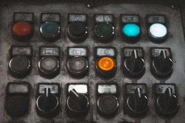 An industrial control panel with various buttons and switches